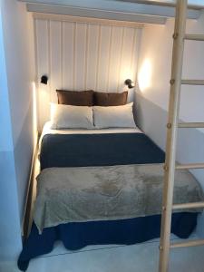 a bedroom with a bunk bed with a ladder at Fisherman Blues in Matosinhos