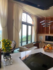 a kitchen and living room with a large window at Hestia View in Fethiye