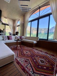 a living room with a couch and large windows at Hestia View in Fethiye