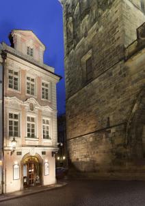 two buildings next to each other in a street at Hotel Pod Věží in Prague