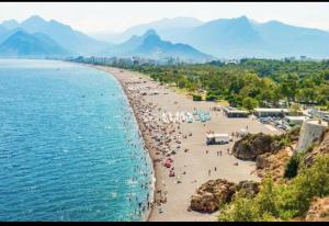 a group of people on a beach with the ocean at Ardor’s apartment in Antalya