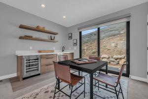 a kitchen with a table and chairs and a window at 3BD Hillside Retreat with Stunning Views in Keetley