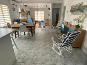 a kitchen and living room with a baby carriage on the floor at Maison d edouard in Saint-Antonin