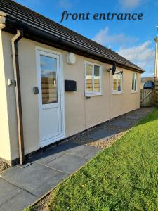 a home with a front entrance with a door at Seaview in Trevilley