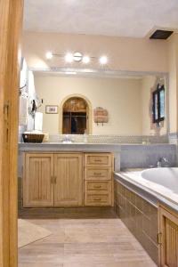 a bathroom with a sink and a large mirror at Casa María Elena in San Miguel de Allende