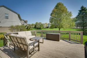 a wooden deck with a couch and a table at Pet-Friendly Vacation Rental in Wixom with Hot Tub! in Wixom
