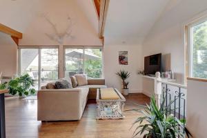 a living room with a couch and a table at Eastern Township's Getaway! Beach + Ski Haven in Magog-Orford