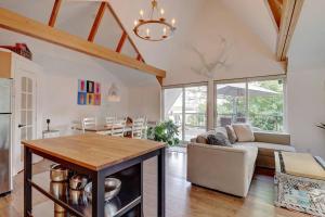 a kitchen and living room with a table and a couch at Eastern Township's Getaway! Beach + Ski Haven in Magog-Orford