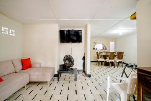 a living room with a couch and a flat screen tv at HABITACION PRIVADA EN CASA DE MIS PADRES in Barranquilla