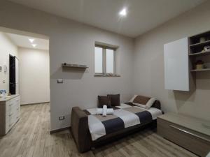 a bedroom with a bed and a dresser at Casa Paolina in Militello in Val di Catania