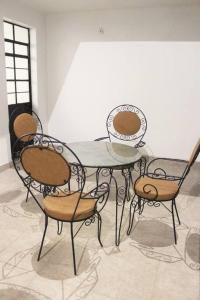 a dining room table with four chairs around it at Casa Tenorio Hospedaje in Orizaba