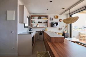a kitchen with white cabinets and a counter top at El Rancho at the Beach in Blanes