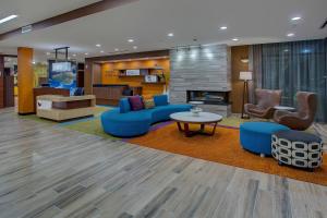 a lobby with blue furniture and a fireplace at Fairfield Inn & Suites by Marriott Nashville Hendersonville in Hendersonville