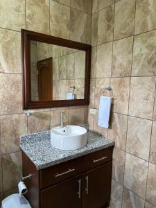 a bathroom with a sink and a mirror at Real Paraiso in Juticalpa