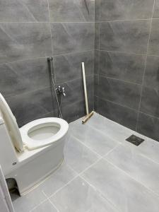 W pokoju znajduje się łazienka z białą toaletą. w obiekcie Durrani House w mieście Islamabad
