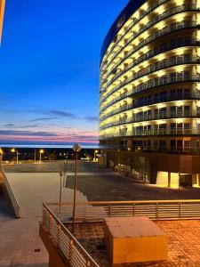 a large building with lights on in front of it at Oasis beach apartment in Figueira da Foz