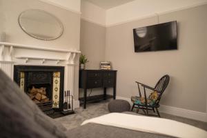 a living room with a fireplace and a mirror at Rose Hill in Shrewsbury