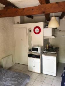 uma pequena cozinha com um micro-ondas e um fogão em STUDIO DE Manon em Allauch