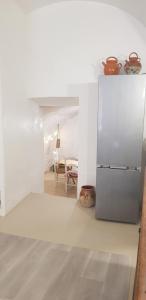 a kitchen with a refrigerator and a dining room at Jolie maison de ville La Petite Magnanerie in La Roque-dʼAnthéron