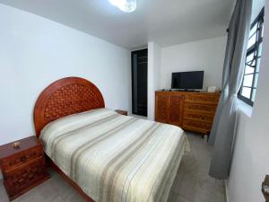 a bedroom with a bed and a television in it at Casa Tenorio Hospedaje in Orizaba