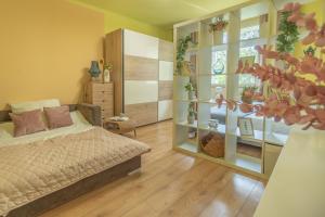 a bedroom with a bed and a glass wall at Apartament Premium Salt in Wieliczka