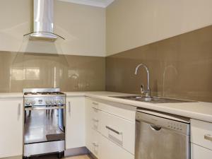 a kitchen with a sink and a stove at Eagle Heights Holiday Units in Eden