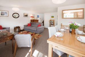 a living room with a table and a couch at Coldstream Coach House in Coldstream