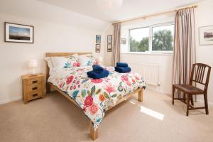 a bedroom with a bed with blue towels on it at Coldstream Coach House in Coldstream