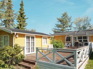a house with a wooden deck in front of it at Holiday home Vig L in Vig