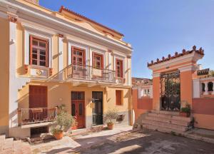 a large house with two balconies on a street at Aetoma Hotel in Nafplio