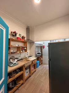 a kitchen with a black refrigerator in a room at Hostel Sun River in Almada