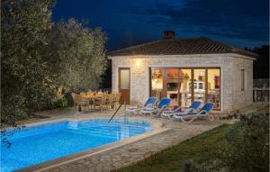 a villa with a swimming pool in front of a house at 4 Bedroom Nice Home In Buje in Buje