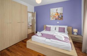 a bedroom with a large bed with purple walls at 4 Bedroom Nice Home In Buje in Buje