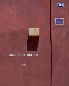 a red metal door with a box on it at Hotel Escondido Oaxaca, a Member of Design Hotels in Oaxaca City