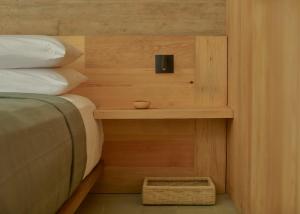 a bedroom with a bed and a nightstand next to a bed sidx sidx sidx at Hotel Escondido Oaxaca, a Member of Design Hotels in Oaxaca City