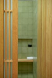a view of a bathroom through a wooden door at Hotel Escondido Oaxaca, a Member of Design Hotels in Oaxaca City