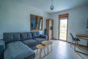 a living room with a blue couch and a table at Villa Modriola heated Pool in Donji Proložac