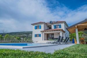 a villa with a swimming pool and a house at Villa Modriola heated Pool in Donji Proložac