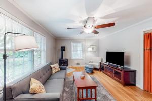 a living room with a couch and a ceiling fan at Sycamore Place Duplex in Atlanta