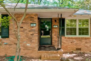 a brick house with a green door and windows at Sycamore Place Duplex in Atlanta