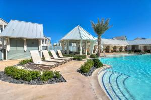 a swimming pool with lounge chairs and a house at Fairway to Heaven in Port Aransas