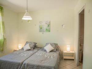 een slaapkamer met een bed met twee lampen erop bij Loustalet Plus in Bagnols-en-Forêt