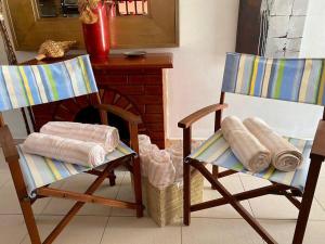two rocking chairs and a fireplace in a room at 3-bedroom villa with a jacuzzi in Noord