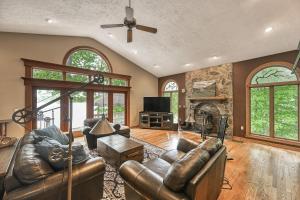 a living room with leather furniture and a fireplace at Windswept Cove in Bumpass