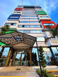 a tall building with colorful windows on it at Puebla Inn Express in Puebla