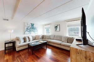 a living room with a couch and a tv at White Marlin 202A in Ocean City