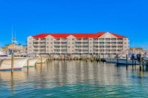 a large building with a marina and boats in the water at White Marlin 202A in Ocean City