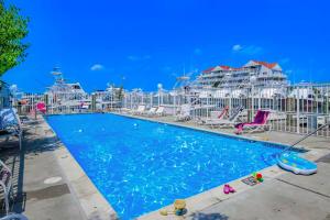 a pool at a resort with chairs and tables at White Marlin 202A in Ocean City