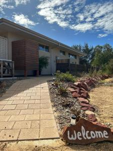 a house with a brick walkway in front of it at Serenity in Style in Kalbarri
