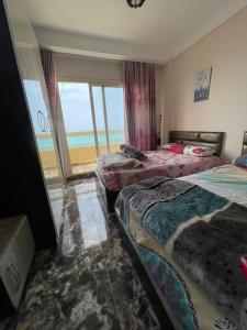 a room with three beds with a view of the ocean at شقه فندقيه مطله على البحر in Marsa Matruh